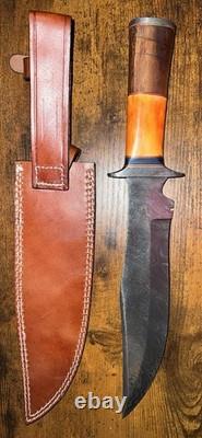 Damascus Steel Hunting Knife with Ornate Handle and Leather Sheath