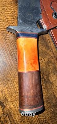 Damascus Steel Hunting Knife with Ornate Handle and Leather Sheath