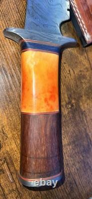 Damascus Steel Hunting Knife with Ornate Handle and Leather Sheath