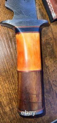 Damascus Steel Hunting Knife with Ornate Handle and Leather Sheath