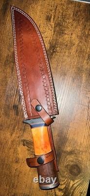 Damascus Steel Hunting Knife with Ornate Handle and Leather Sheath